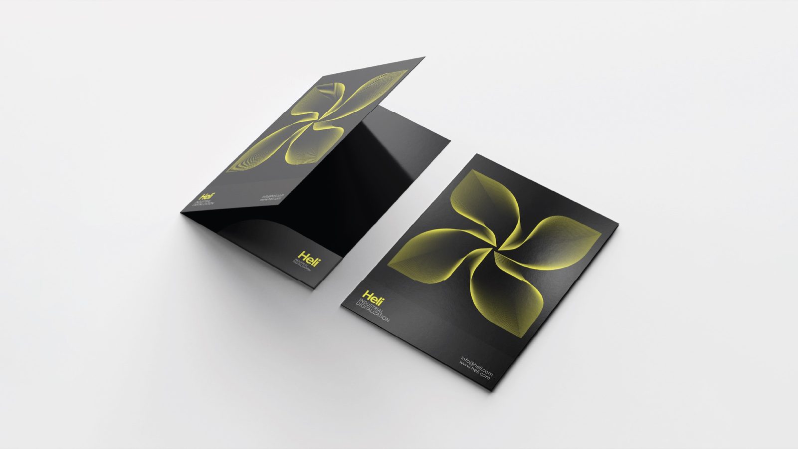 Heli folders in black, marked with the glowing yellow pinwheel monogram.